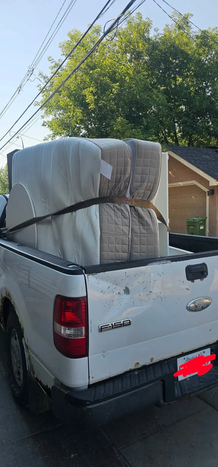 Mattresses strapped into the MC-Clean pickup truck bed